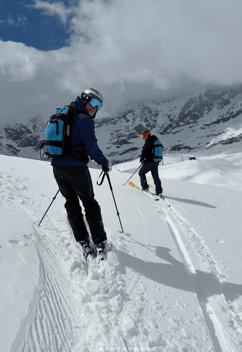 Two skiers on a skin track under low cloud
