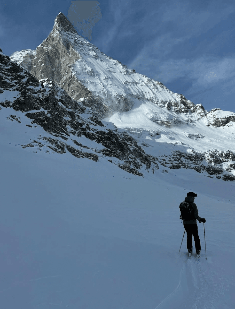 A skier climbing high toward the Plateau Rosa glacier